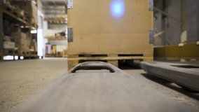 Pallet jack lifting wooden crate in warehouse. Manual cargo handling and warehouse logistics process - Powered by Shutterstock - Get 15% off with code: PIKWIZARD15