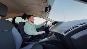 A man in a car. The man is smiling. Slow motion. High-quality 4K footage. - Powered by Shutterstock - Get 15% off with code: PIKWIZARD15