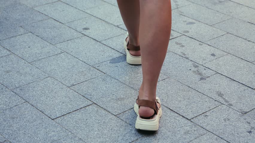 Female feet, walking steps close up. Tourist walking. High quality 4k footage