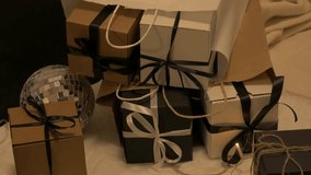 Christmas-themed scene featuring elegantly wrapped parcels and a decorative wreath, creating a warm festive atmosphere, camera zooms in for detail. Parcel christmas concept - Powered by Shutterstock - Get 15% off with code: PIKWIZARD15