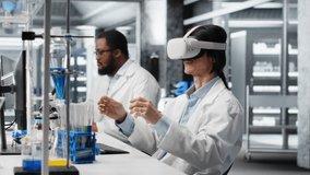 Lab specialist wearing VR headset equipment using chemical fluids for experiments. Chemist uses virtual reality device to simulate using solution laboratory glassware at workstation, camera B - Powered by Shutterstock - Get 15% off with code: PIKWIZARD15