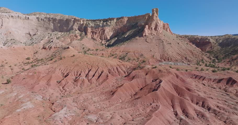 Vast New Mexico desert landscape with red cliffs under a clear blue sky