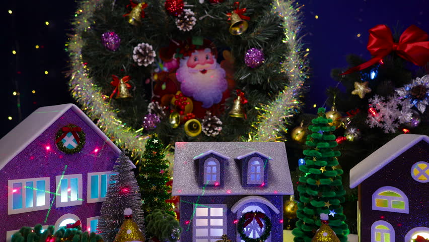 Against the backdrop of a large Christmas tree and a Christmas wreath in a Christmas town, colorful cars and snowmen stand in front of the houses