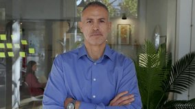 Confident mid adult businessman standing at modern office, wearing formal attire and smiling with success and professionalism. Leadership and corporate confidence concept. - Powered by Shutterstock - Get 15% off with code: PIKWIZARD15