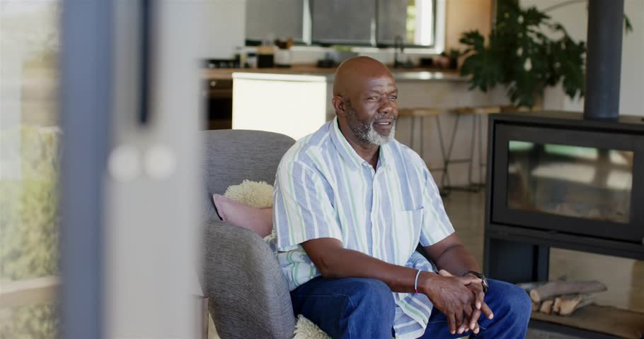 Senior man sitting in seat getting social media alerts, bubbles orbiting head showing rising reach. Notifications, armchair, home, elder, modern, decor, smile