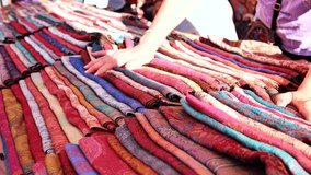 Person browsing colorful handcrafted Indian textiles and scarves at a bustling market in India - Powered by Shutterstock - Get 15% off with code: PIKWIZARD15