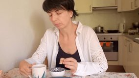 woman drinks coffee, woman enjoys morning coffee ritual, she relaxes with tea and biscuit in morning, woman savors her breakfast with coffee and peaceful moment - Powered by Shutterstock - Get 15% off with code: PIKWIZARD15