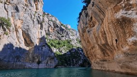 Boat trip on turquoise water of mountain canyon, Verdon Gorge in french Alps, Provence France. Near Aiguines. Canyon is about 25 kilometres long and up to 700 metres deep. - Powered by Shutterstock - Get 15% off with code: PIKWIZARD15