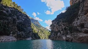 Boat trip on turquoise water of mountain canyon, Verdon Gorge in french Alps, Provence France. Near Aiguines. Canyon is about 25 kilometres long and up to 700 metres deep. - Powered by Shutterstock - Get 15% off with code: PIKWIZARD15