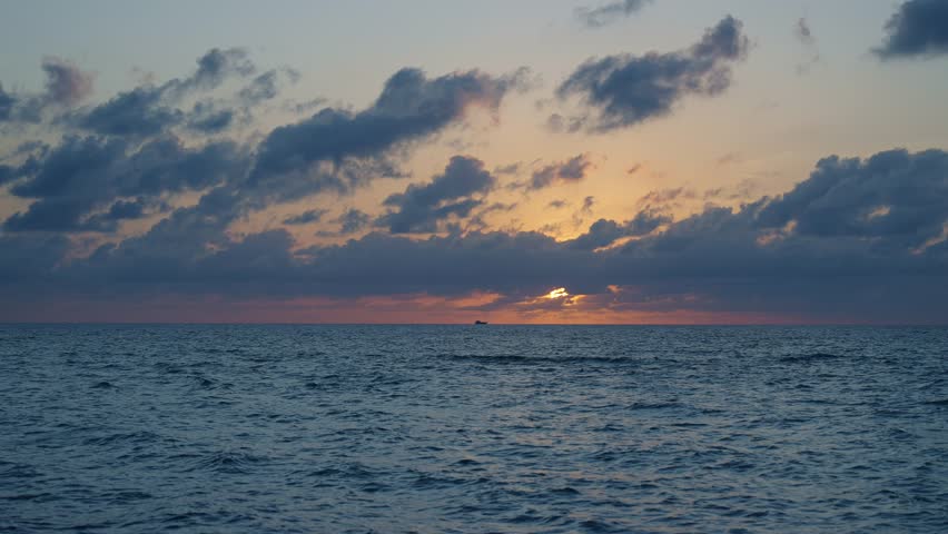 Sunset cloudy sky. Seascape at summer vacation. Skyscape with sea horizon. Horizon sunrise sea with ship. Sunrise seascape. Romantic summer vacation seascape. Sea sunset horizon. Golden hour