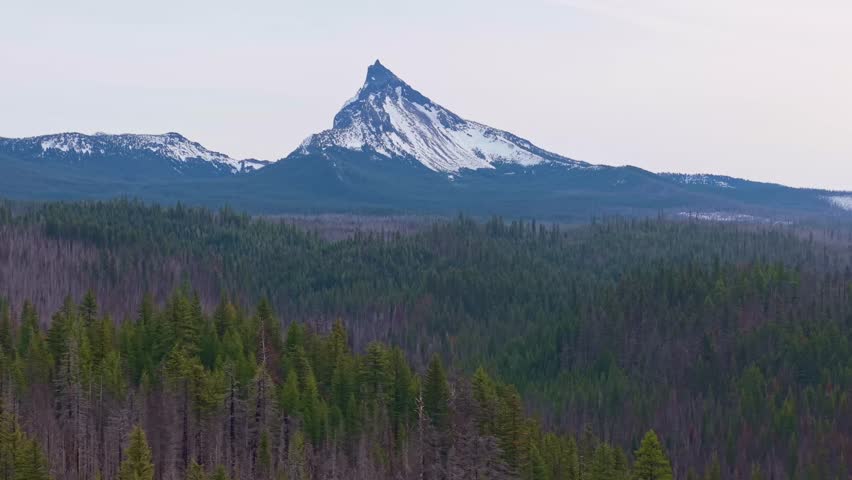 A commanding aerial view of the dramatically peaked Mount Thielsen, a distinctive former volcano, located in the Cascade Range near Crater Lake National Park in Southern Oregon