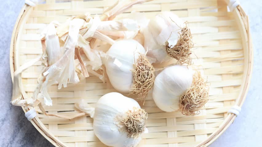 bunch of garlic cloves on a basket