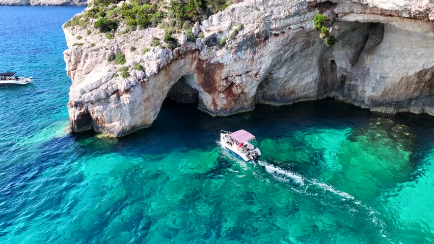 Aerial drone cinematic video of scenic paradise complex of blue caves in Northern part of Zakinthos island a tourist attraction visited by small boats and cruises, Ionian, Greece
