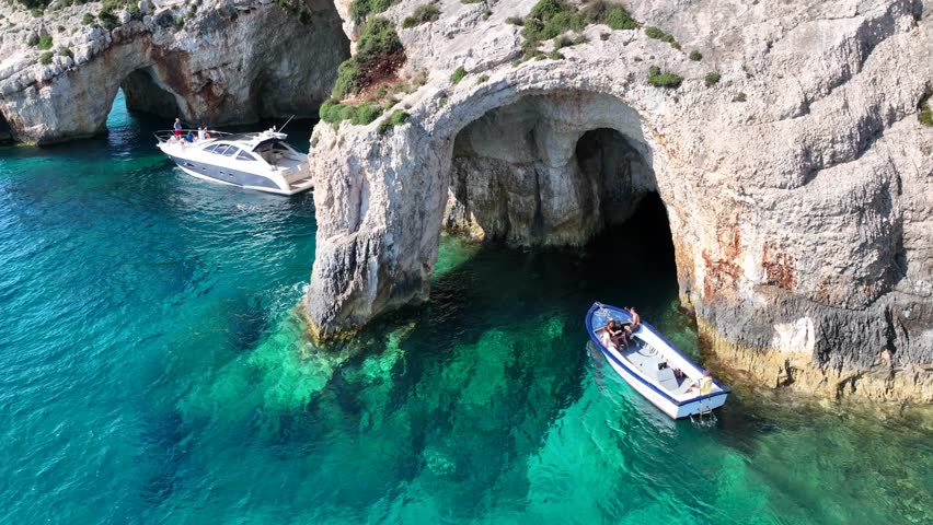 Aerial drone cinematic video of scenic paradise complex of blue caves in Northern part of Zakinthos island a tourist attraction visited by small boats and cruises, Ionian, Greece