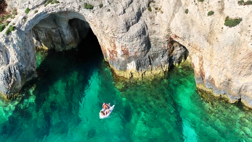 Aerial drone cinematic video of scenic paradise complex of blue caves in Northern part of Zakinthos island a tourist attraction visited by small boats and cruises, Ionian, Greece