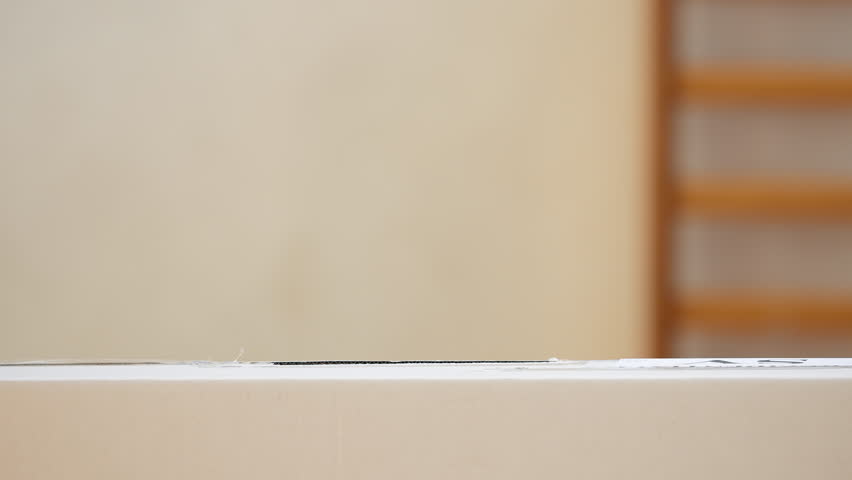 Close-up of voter inserting ballot into the ballot box on election day