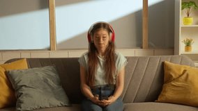 Music and human emotions split personality advertisement concept. Portrait of person in the room. Woman in headphones watching music video on smartphone, jams to the song at same time. Double exposure - Powered by Shutterstock - Get 15% off with code: PIKWIZARD15