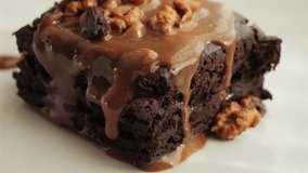 Chocolate cake with nuts and salted caramel. Delicious brownies on a plate. High quality 4k footage - Powered by Shutterstock - Get 15% off with code: PIKWIZARD15