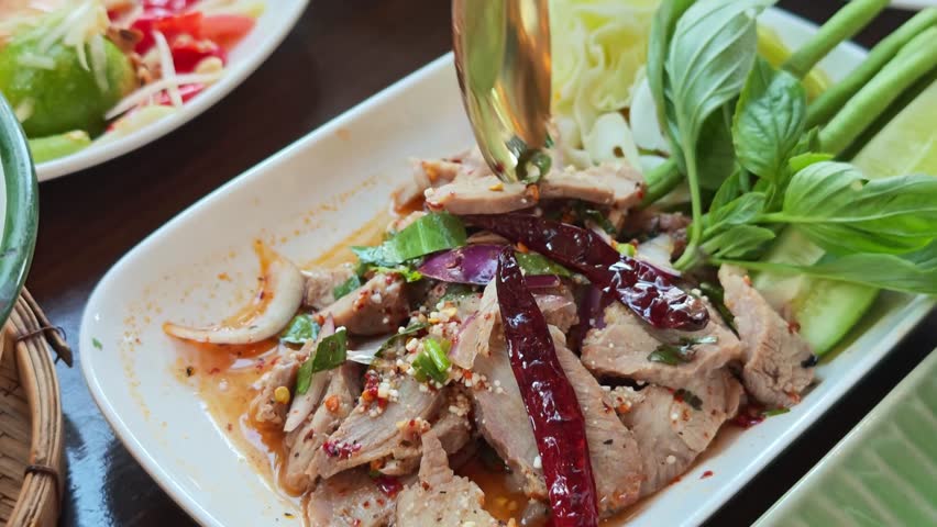 Grilled pork salad on a plate in an Isaan restaurant