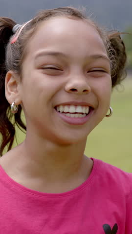 Vertical video: Sunlit field showing girl reading book then kids doing yoga, painting, hugging. Outdoor, education, mindfulness, creativity, friendship, nature, vertical video