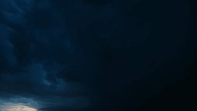 Lightning flashes illuminate textured storm clouds as they roll across the night horizon. A moody timelapse showcasing thunder, atmosphere, and the immense power of nature in motion - Powered by Shutterstock - Get 15% off with code: PIKWIZARD15