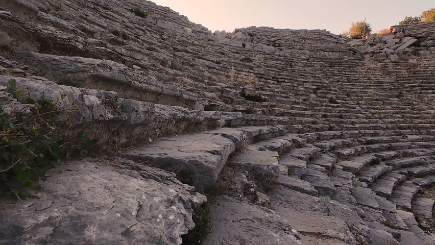 Listening to the silent ancient theater of Selge, Antalya. Stone steps whisper echoes of forgotten performance beneath the mountain sky.