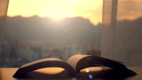 Sunlight streams through window, casting warm glow on open book placed on table. Tranquil atmosphere encourages study and reflection. Ideal for educational themes and reading. - Powered by Shutterstock - Get 15% off with code: PIKWIZARD15