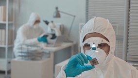 A skilled engineer in protective gear inspects a computer chip under lab lighting, focusing on precision.
 - Powered by Shutterstock - Get 15% off with code: PIKWIZARD15