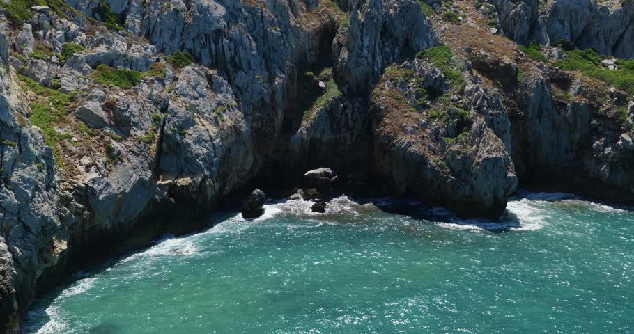 Spiaggia di Cala Domestica Secluded Cove On The Southwestern Coast Of Sardinia Near Buggerru In Italy. Aerial Pullback Shot