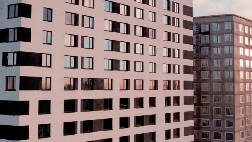 Close view of residential apartment blocks with repeating windows.