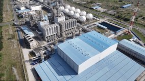 Aerial footage of a large industrial plant with buildings, pipes, and infrastructure. - Powered by Shutterstock - Get 15% off with code: PIKWIZARD15