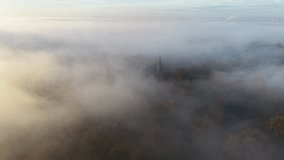 Church steeple rises through misty morning fog Epping Forest UK drone,aerial - Powered by Shutterstock - Get 15% off with code: PIKWIZARD15