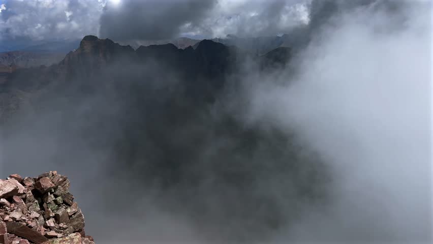 Pyramid Peak Aspen Snowmmass summer aerial drone fog stormy weather clouds Maroon Peak Maroon Bells Wilderness hiking fourteener Colorado Elk Range Rocky Mountains rugged terrain pan left