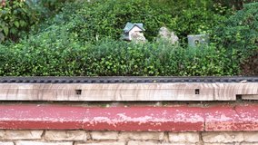 Miniature green train moving through garden landscape - Powered by Shutterstock - Get 15% off with code: PIKWIZARD15