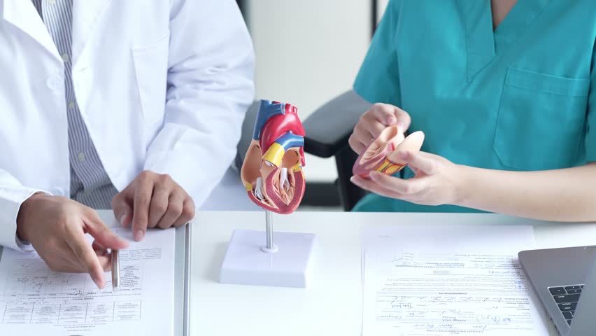 Doctor Holding Medicine Bottle Explaining Dosage to Patient