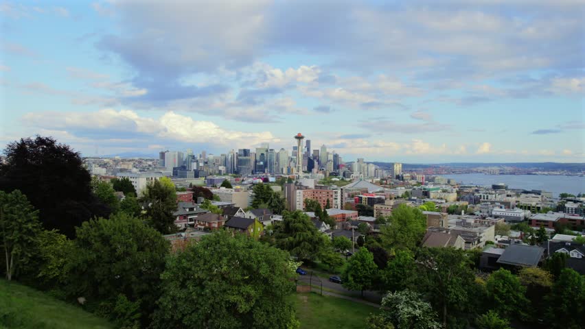 Dolly in aerial toward Seattle skyline from residential hilltop near Kerry Park