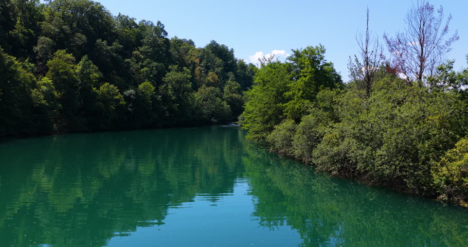 Clear, Emerald-green Waters With Dense Trees At Mreznica River In Central Croatia. Aerial Dolly Shot