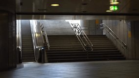 Stairway and escalator inside a train station, showing commuters, urban transit, and public transportation infrastructure in 4K. - Powered by Shutterstock - Get 15% off with code: PIKWIZARD15