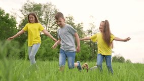 Child run across green field with girl and boy play on tall grass during summer day nature backdrop with tree line and smile on face casual clothing carefree motion friendship laugh playful energy - Powered by Shutterstock - Get 15% off with code: PIKWIZARD15