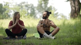 Couple Meditating Together In Park, Outdoor Yoga And Mindfulness Practiceю Man And Woman Sitting Cross-Legged, Health And Wellness Lifestyle, Spiritual Connection With Nature, Inner Peace And Balance - Powered by Shutterstock - Get 15% off with code: PIKWIZARD15