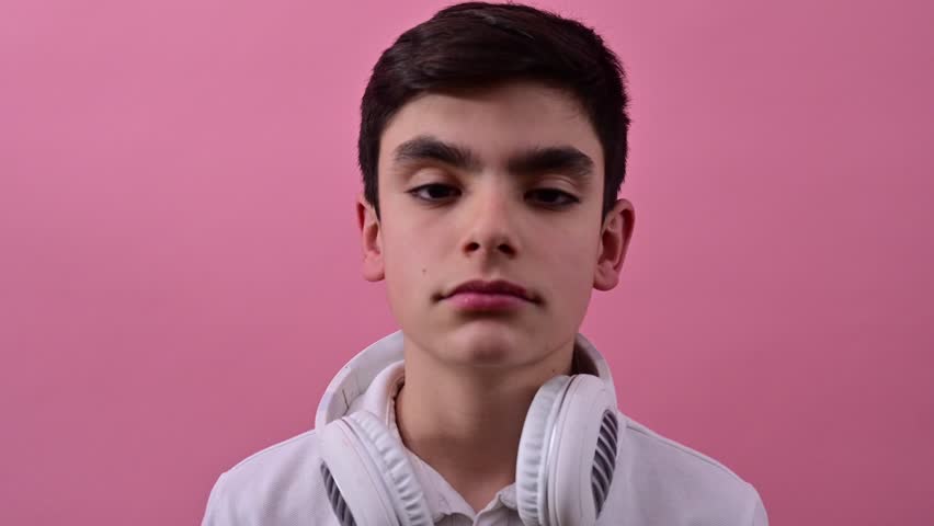Teenage boy dancing and enjoying music with wireless headphones