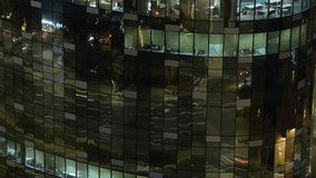 Dynamic traffic reflections on a glass skyscraper in a nighttime time lapse. Vibrant flowing vehicle headlight and taillight light trails in a mesmerizing urban facade - Static, artistic vibe - Powered by Shutterstock - Get 15% off with code: PIKWIZARD15