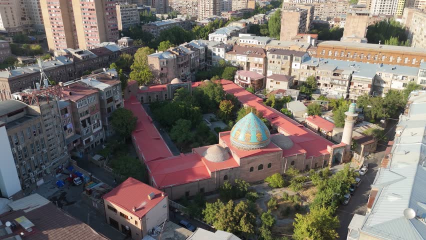 Aerial drone view of the Blue Mosque in Yerevan, Armenia. The footage shows the beautiful Persian-style mosque surrounded by city buildings in downtown Yerevan. 