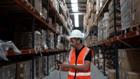 Focused male logistics worker wearing a hard hat and safety vest using a handheld scanner to check inventory on shelves in a large distribution center, managing cargo and supply chain operations - Powered by Shutterstock - Get 15% off with code: PIKWIZARD15