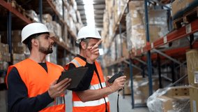 Two warehouse workers in safety gear collaborating to manage inventory, one using a barcode scanner on boxes and the other entering data on a digital tablet while checking stock on tall shelves - Powered by Shutterstock - Get 15% off with code: PIKWIZARD15