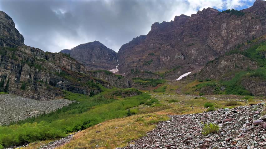 Maroon Bells Wilderness Maroon Peak Crater Lake green summer valley Colorado clouds movement Aspen Snowmass rugged terrain Elk Range Rocky Mountains White River Forest blue sky sunset zoom in