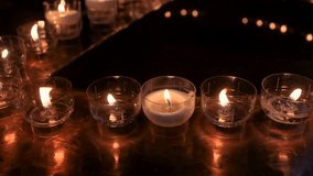 Round candelabra with lit candles in a Catholic cathedral. Religious holiday - Powered by Shutterstock - Get 15% off with code: PIKWIZARD15