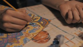 beautiful girl draws a mandala in a room with a ginger cat. Close-up - Powered by Shutterstock - Get 15% off with code: PIKWIZARD15