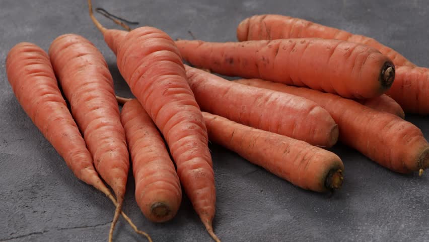 whole baby carrots close up zoom grey surface