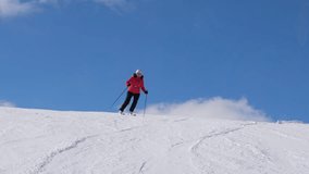 Skis create spray of snow powder. Sunny day with skier carving down on snowy piste in mountain resort. Person enjoying winter holiday with some alpine skiing. People living active lifestyle outdoors - Powered by Shutterstock - Get 15% off with code: PIKWIZARD15